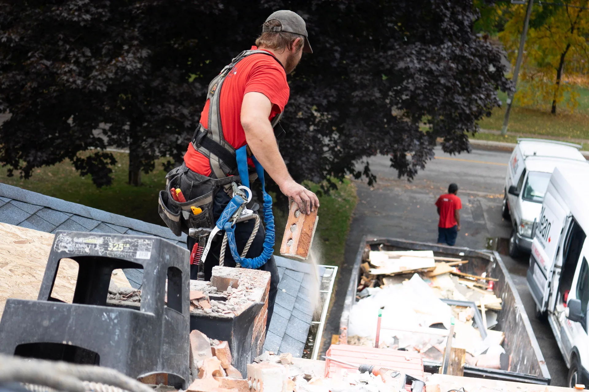 Western Mass junk removal crew loading debris into a dumpster